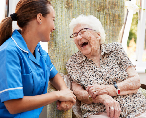 A doctor and an elderly patient have a pleasant interaction