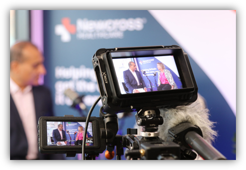 Professional video camera setup recording speaker at branded event for Blue Lozenge thought leadership podcast production