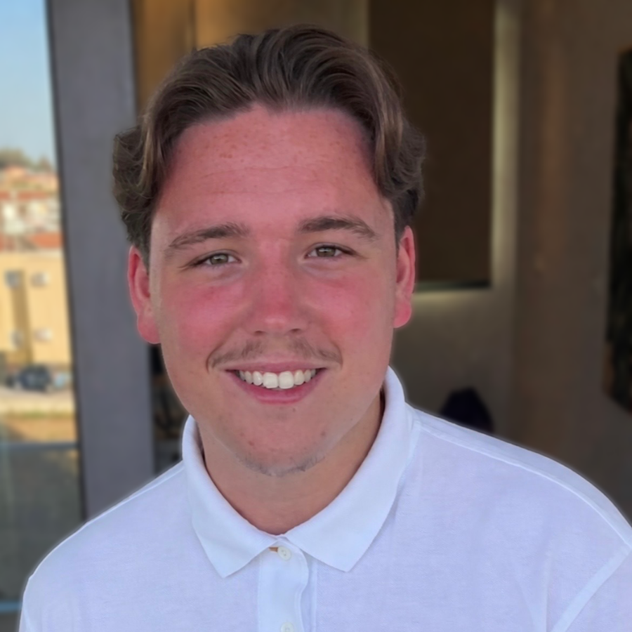 Headshot of Aaron, a member of the Blue Lozenge team, smiling at the camera outdoors.